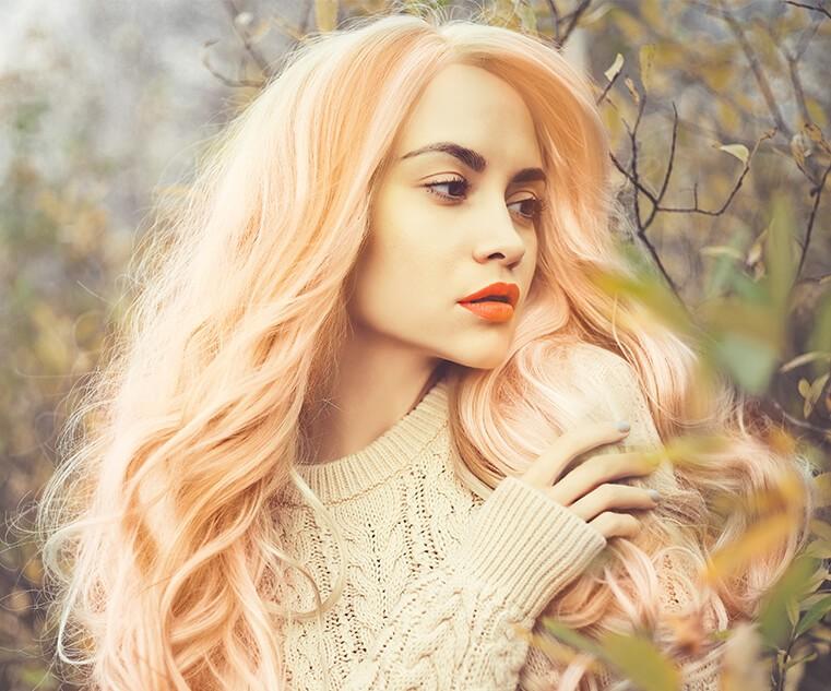 Pastel hair in a soft peach shade creates a happy, light, summery look.